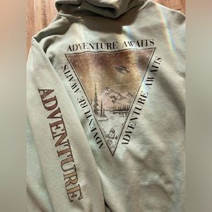 hoodie, with adventure on the sleeve,a triangle on the front,back with mountains